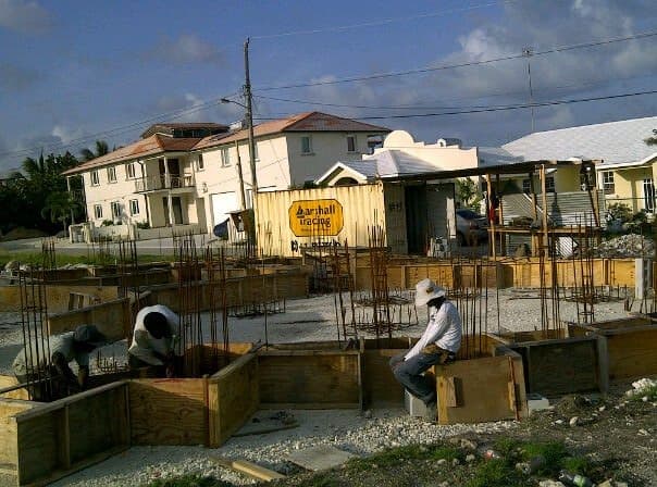 Workers preparing rebar footings on a foundation site