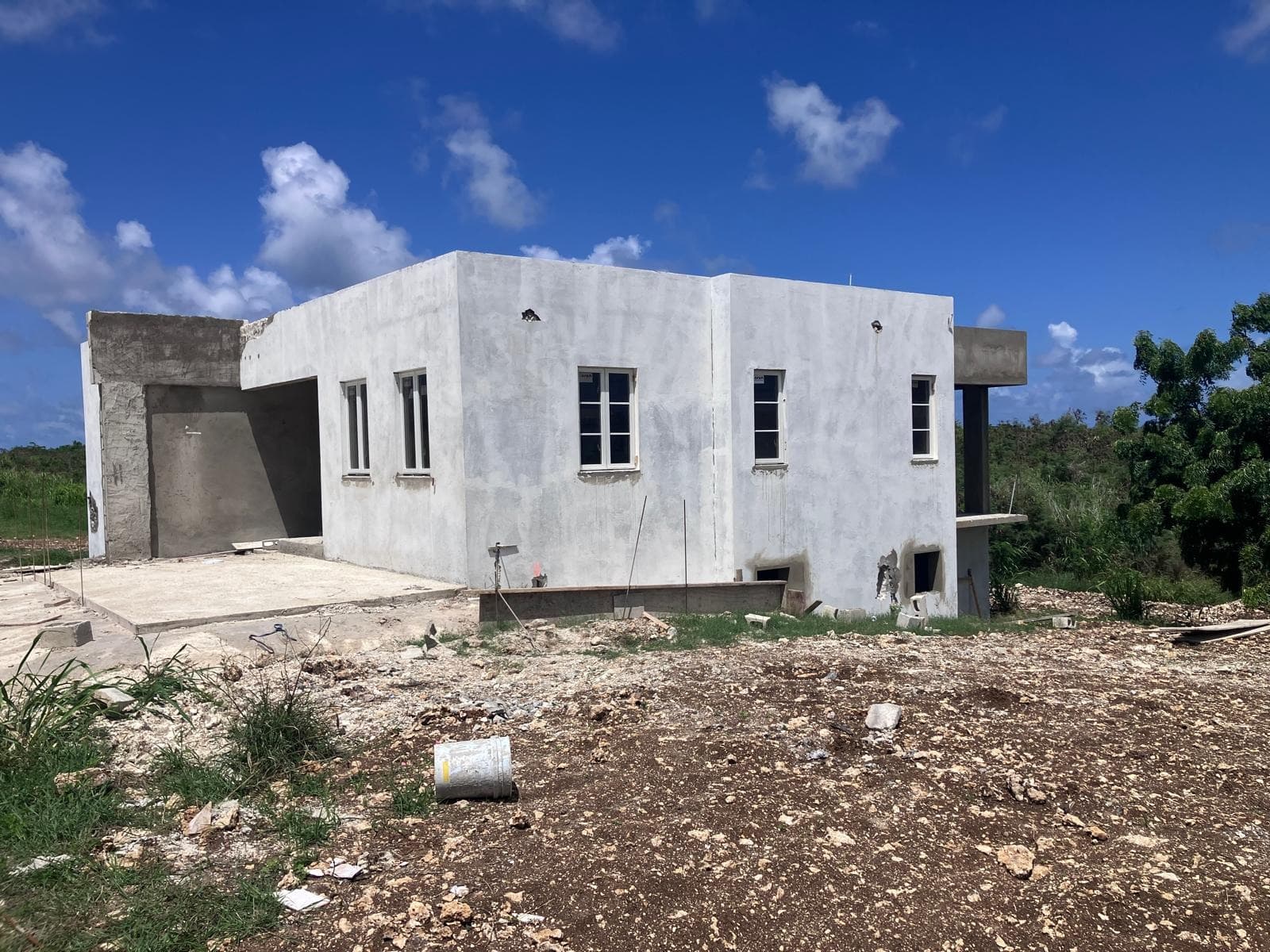 Two-storey residence with exterior plaster complete, awaiting paint and finishes