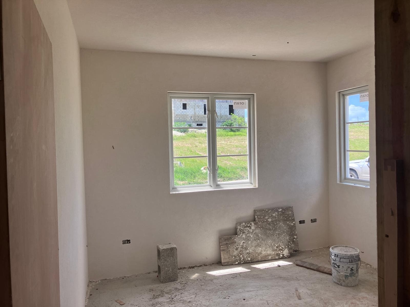 Interior room with windows installed and neighbouring property visible outside