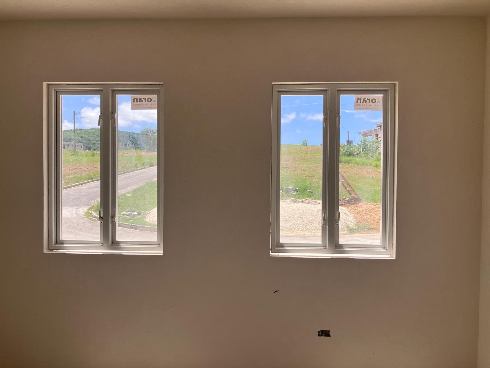 Plastered interior room with two windows and natural daylight