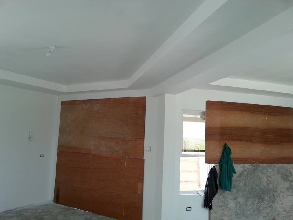 Interior wall with plywood panel installation in progress