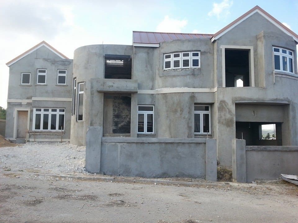 Unfinished residence exterior in grey block and render, structural stage