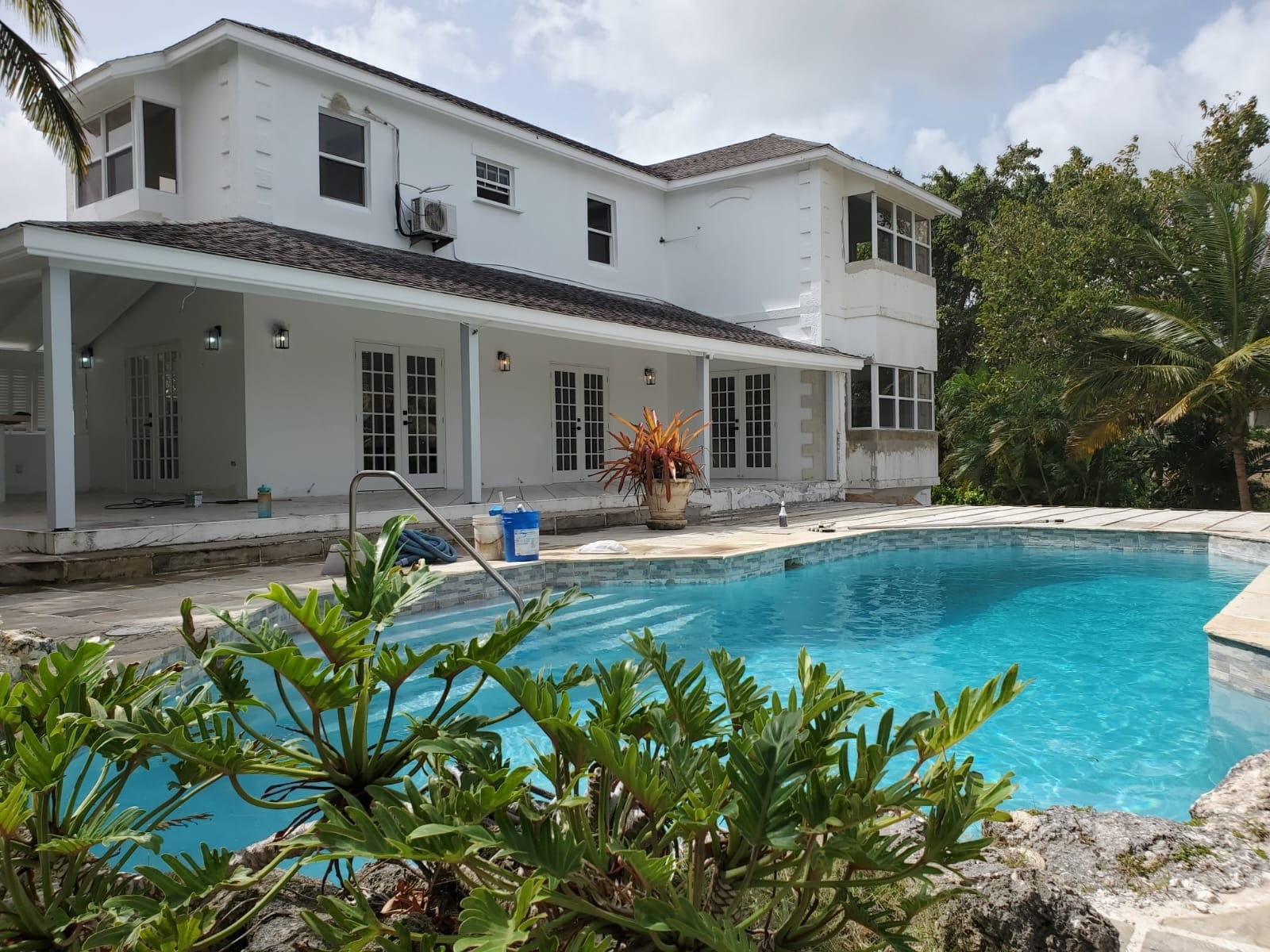 Completed pool terrace with palm landscaping at a private Barbados residence