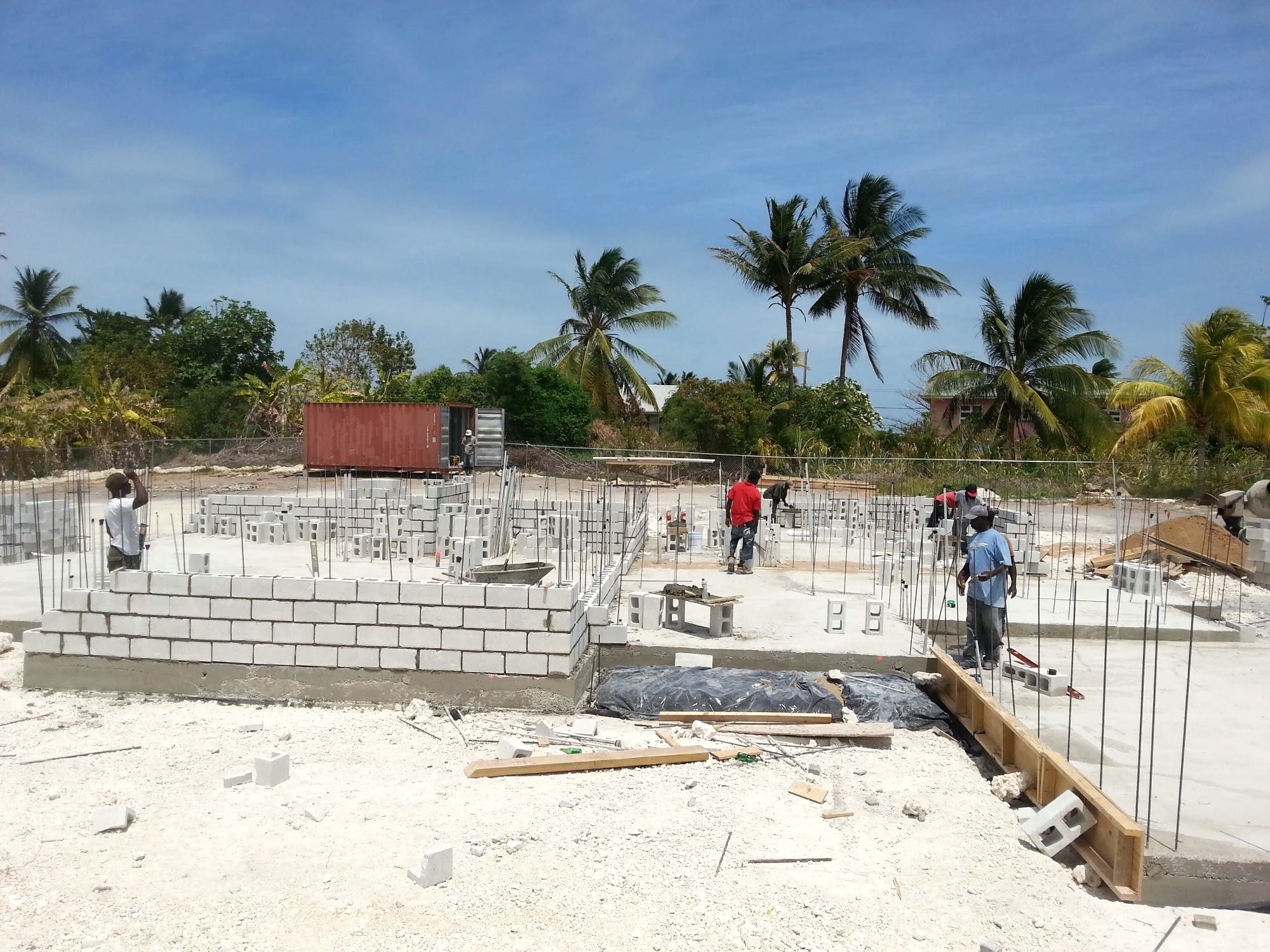 Concrete blockwork walls under construction with structural framing