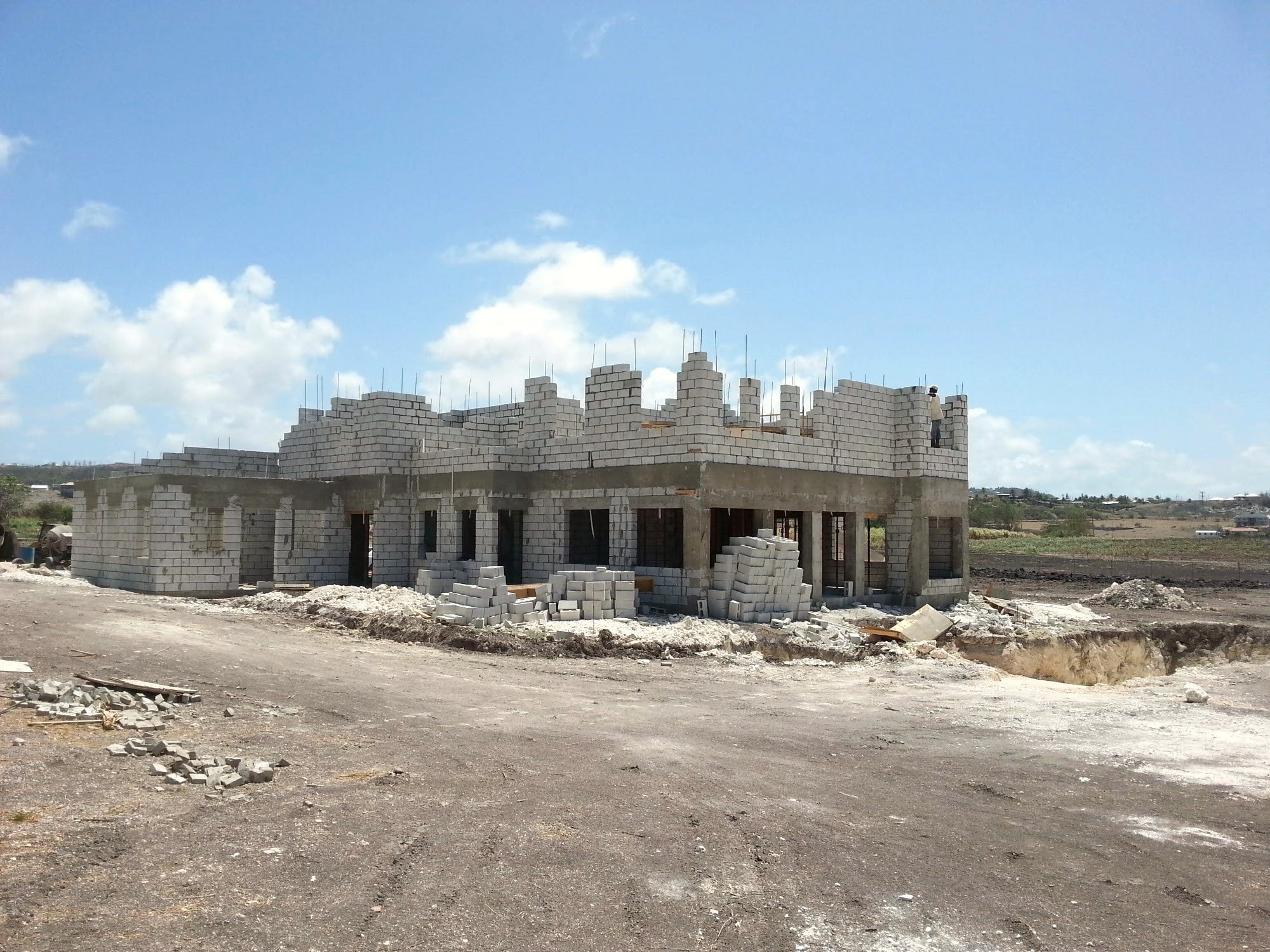 Two-storey structural shell under construction with scaffolding