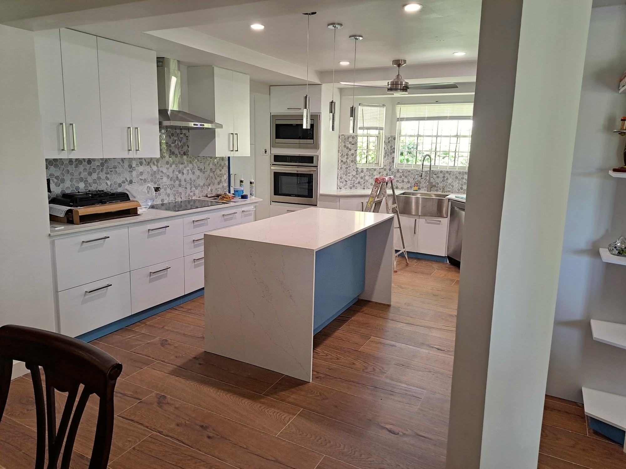 Renovated open-plan kitchen with island seating and stainless steel appliances