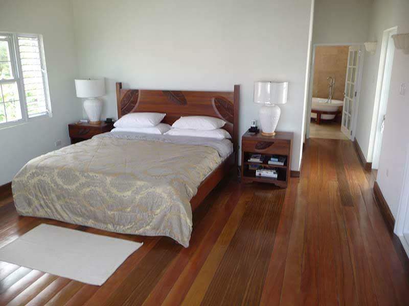 Bedroom with hardwood floors and timber bed frame