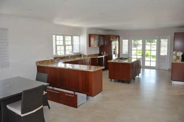 Kitchen with cherry wood cabinetry and French doors to garden